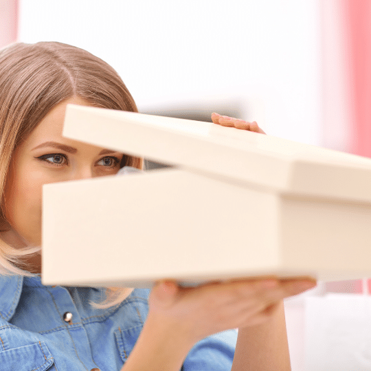 Woman peeks into box